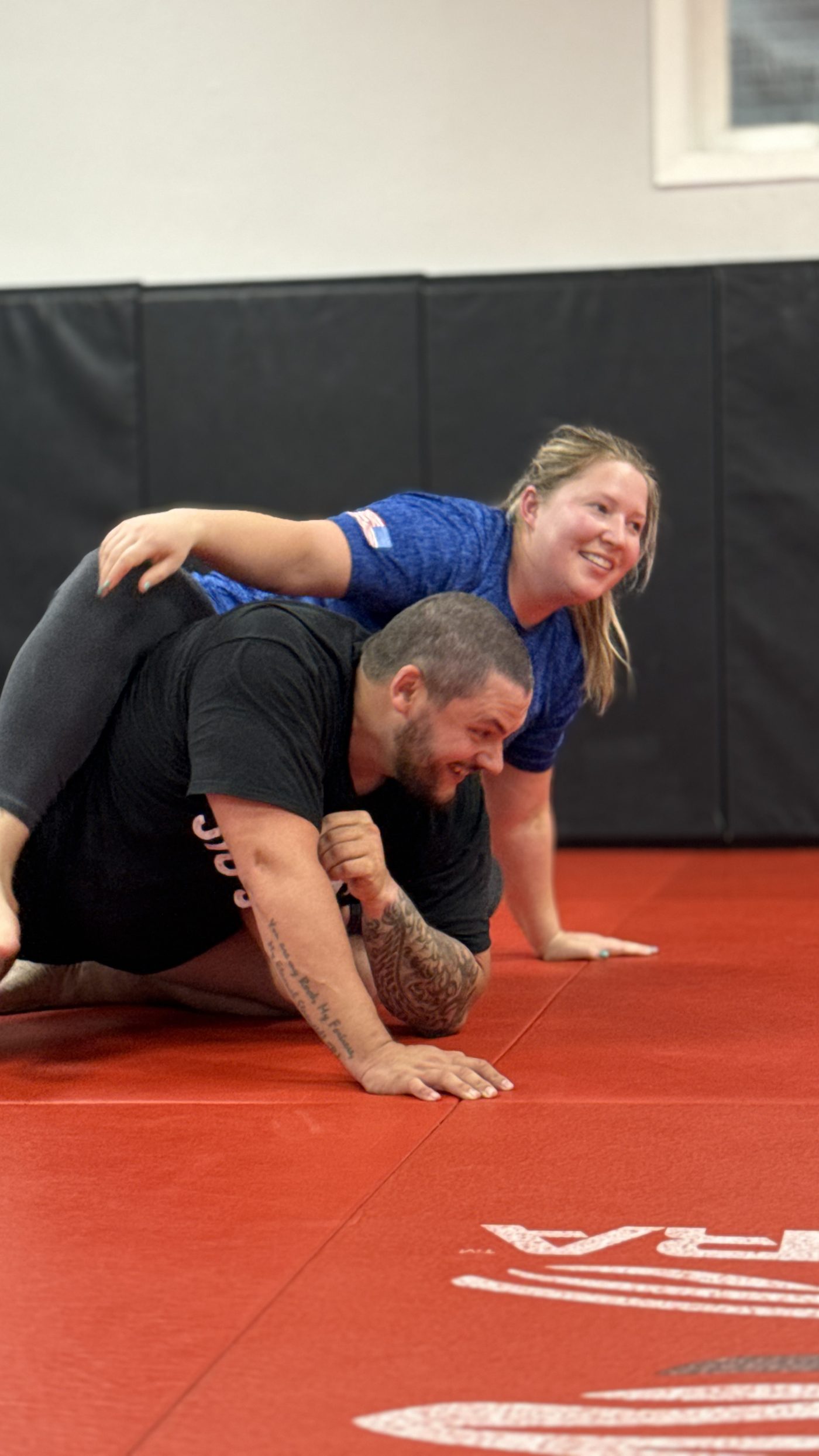 A newer student practicing top control with a training partner during a beginner-friendly class at Northstar Jiu Jitsu