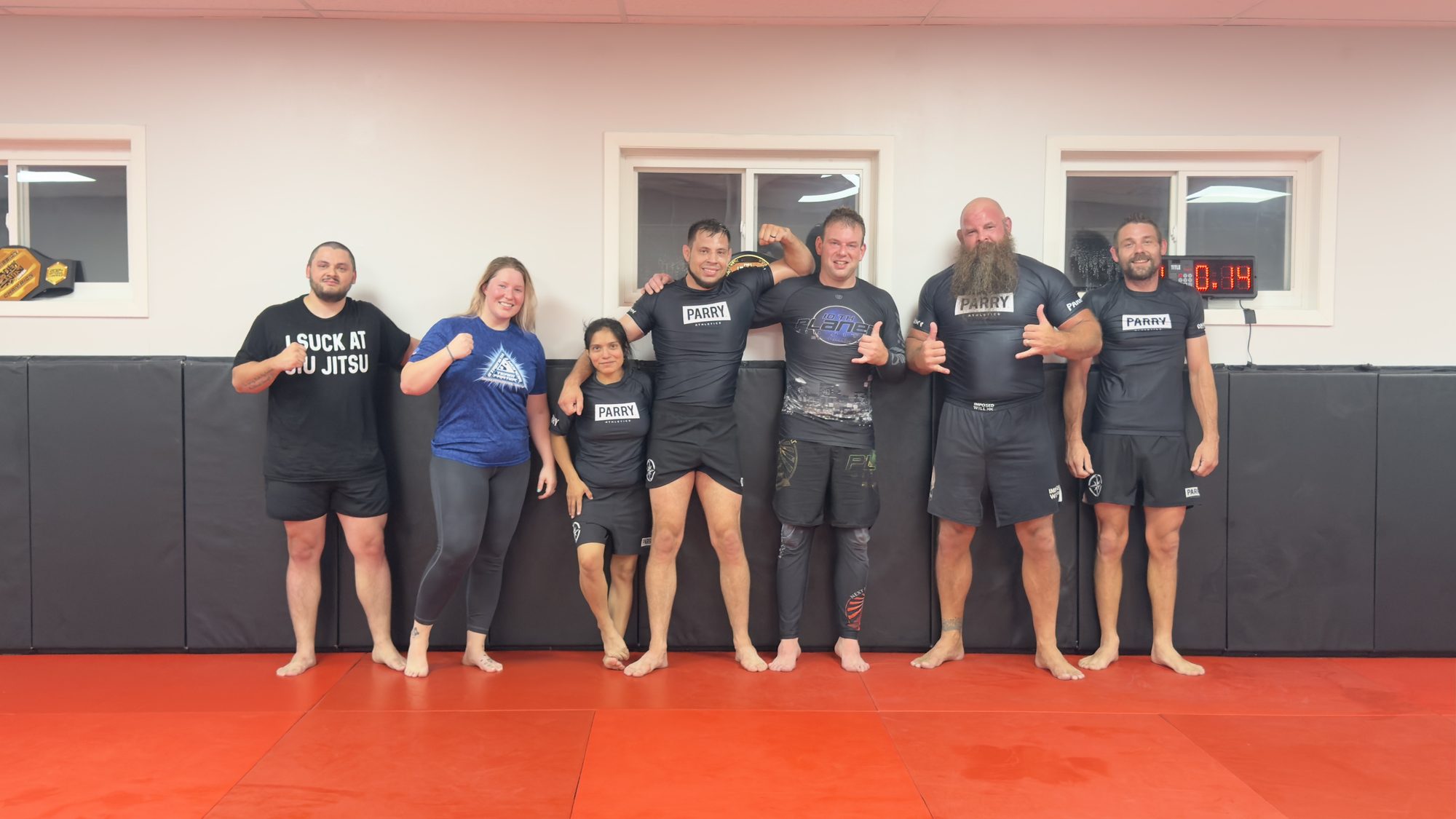 Adult students and coaches together on the mat after an evening no-gi class at Northstar Jiu Jitsu in Eau Claire