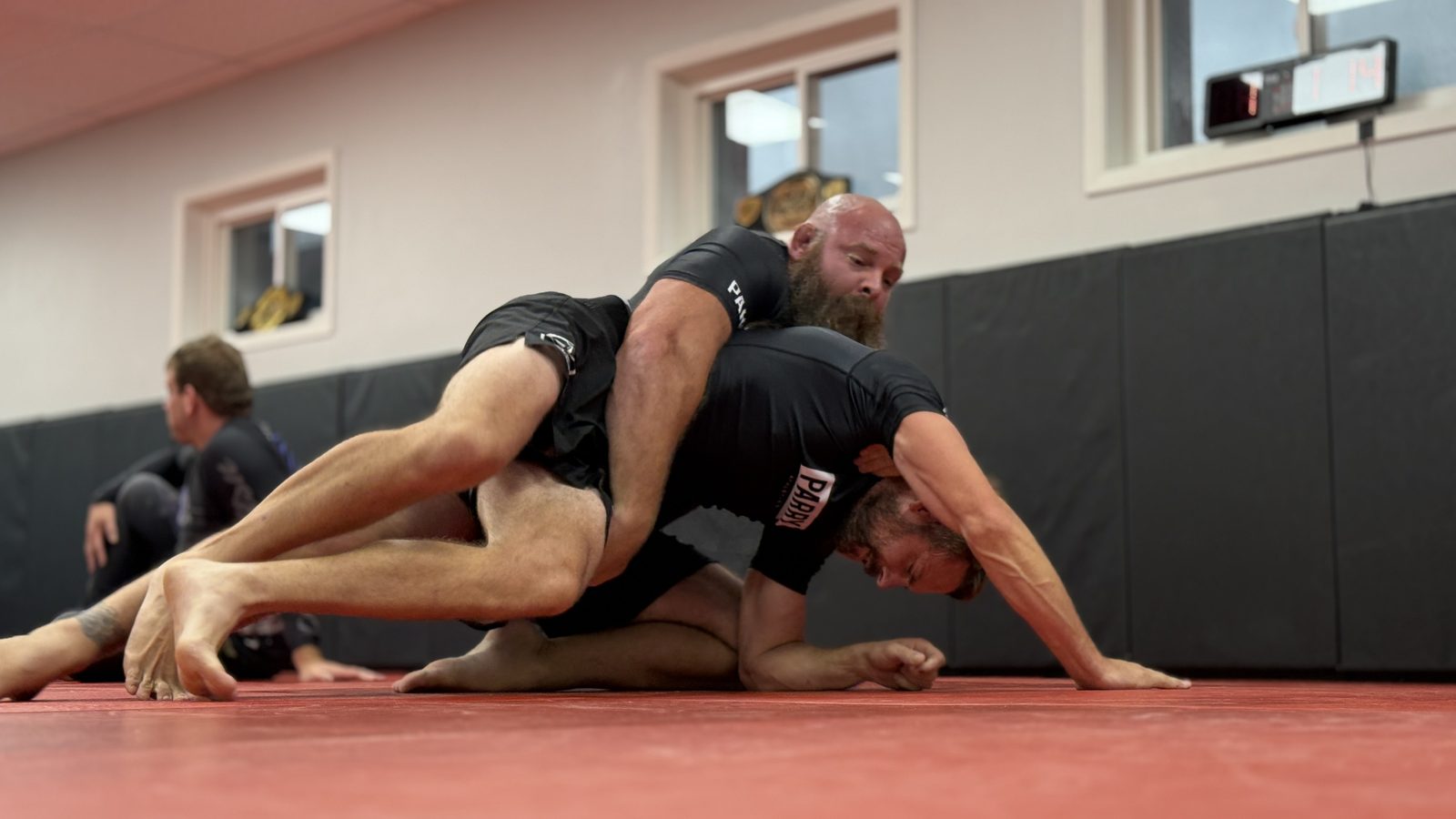 Two adult students working through a controlled position during an All Levels no-gi class at Northstar Jiu Jitsu in Eau Claire