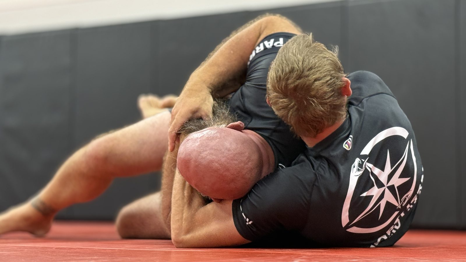Two students holding a controlled position during a live round at Northstar Jiu Jitsu in Eau Claire