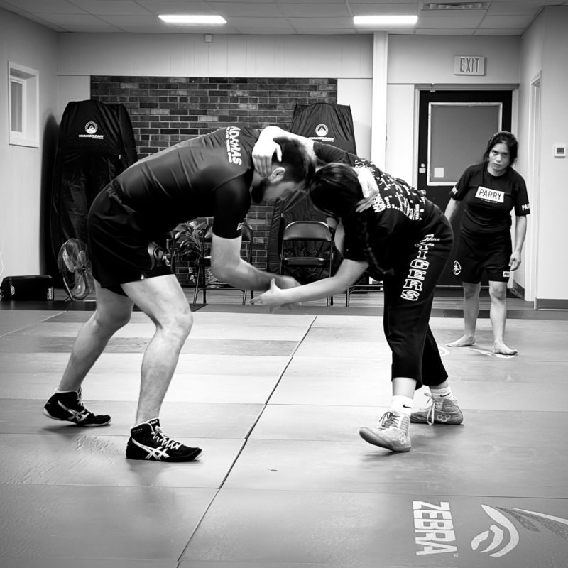 Two wrestlers hand fighting from a standing stance on the mat during open mat at Northstar Jiu Jitsu in Eau Claire